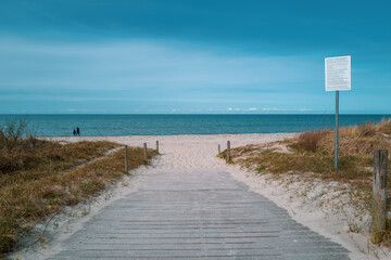 path leads to the blue water of the Baltic Sea and the sky is blue