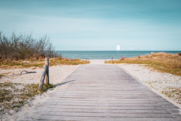 path leads to the blue water of the Baltic Sea and the sky is blue