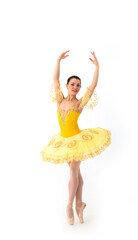 Naklejka premium Young modern ballerina with yellow tutu doing the pose on white background.