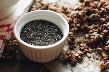Chia seeds with homemade granola. Delicious and healthy breakfast with raspberries. Morning aesthetics and beautiful layout on a wooden table. Granola for healthy breakfast.