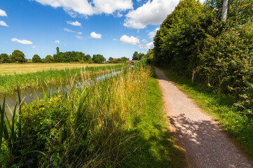 Towpath by British Canal on beautiful sunny summer day. - 426925593