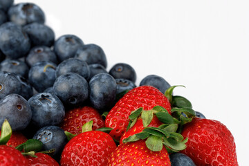 Strawberries and blueberries isolated on a white background. Diagonal line from left to right