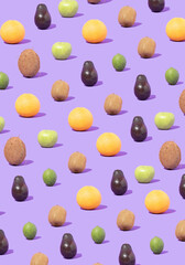 Trendy sunlight pattern made of colorfull fresh fruit against pastel violet background. Flat lay.