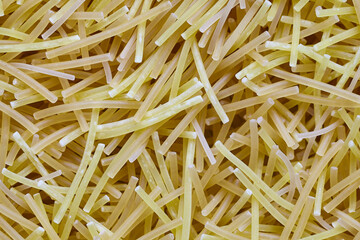 Egg noodles or spaghetti pasta, macaroni, noodle texture background macro closeup Top View. Concept of healthy eating, protein diet and vegetarianism.