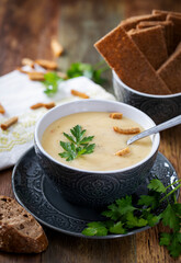 Soup - mashed potatoes in a gray cup on a wooden table