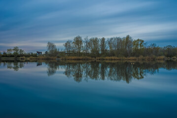 Fototapeta na wymiar Panoramic landscape with the fishing lake near Ketsch in Germany.