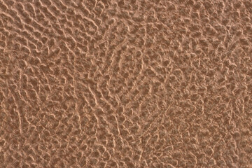 Ceramic tile light brown leather effect background. Closeup texture