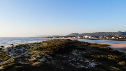 Aerial view of the Northern Litoral Natural Park in Ofir, Fao, Esposende, Portugal at sunset. The two sides of Restinga de Ofir. One facing the ocean, the other the estuary of Cávado River.