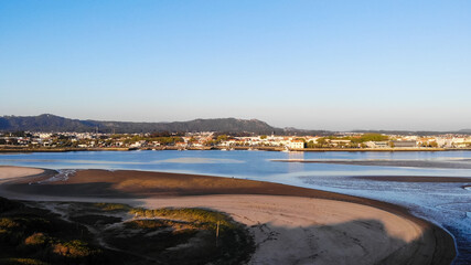 Fototapeta na wymiar DRONE AERIAL FOOTAGE - The Northern Litoral Natural Park in Ofir, Esposende, Portugal. The Cavado River estuary at sunset.