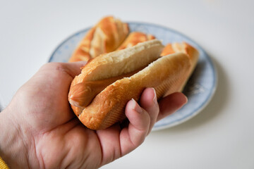 close-up of hand holding hot-dog