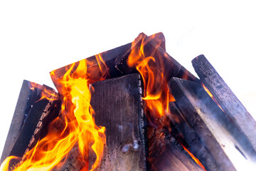 A large fire made of planks. Firewood in a bright flame. Bonfire on a white background.