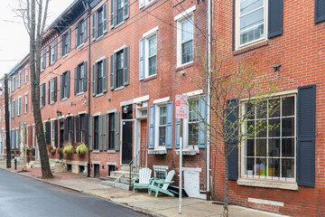 Rows of brownstone apartment buildings in Center City with chairs, stoops and planters in Pennsylvania