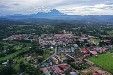 Fototapeta premium aerial view of tuaran town with mount kinabalu on background