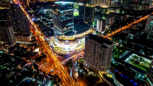 Bangkok business district city center above Samyan area and traffic, with buildings and skyscrapers, during night, zoom in – Time Lapse