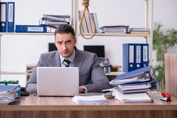 Young male employee committing suicide at workplace