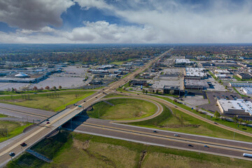 Fototapeta premium Aerial view of highway interchange with traffic on a bridge and streets roads and lanes crossroads cars near Fairview Heights Illinois USA