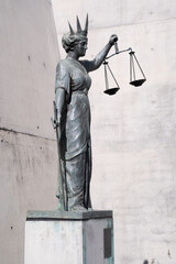 Statue of Lady Justice with the sword in one hand and the scales of justice in the other