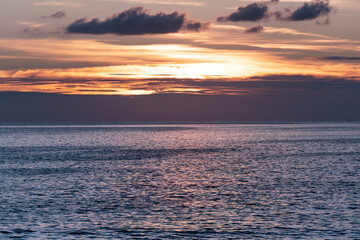 Amazing colorful clouds in sunset time Beautiful light of nature over sea Amazing colors of the setting sun Majestic clouds flowing in sunset Golden hour sky Evening dark clouds