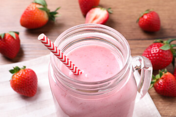 Delicious strawberry drink in mason jar on table, closeup