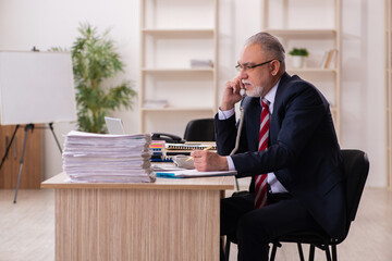 Old businessman employee sitting in the office