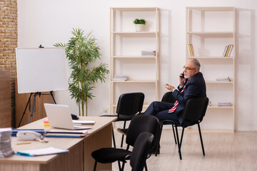 Old businessman employee in front of white board