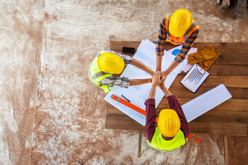 Top view of Team work construction hand coordination engineer and architects working meeting discussing designing planing measuring layout of building blueprints in construction site