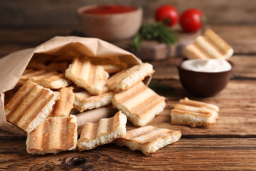 Fototapeta na wymiar Delicious pita chips on wooden table, closeup