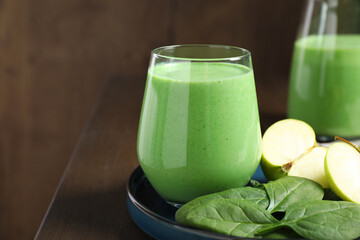 Tasty fresh spinach and apple smoothie on wooden table, space for text