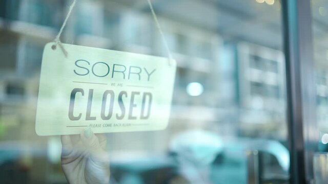 shop owner closing store due to pandemic period, worker flipping sign "open" to "closed", Business during quarantine, economic crisis, safety measures, protection healthcare