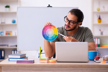 Young male designer working in the office