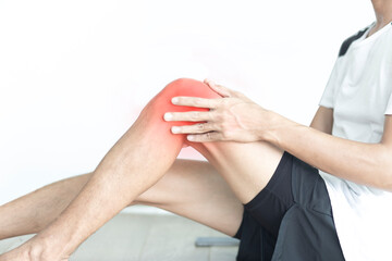 Young man have knee pain during exercise and white background