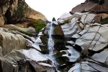 cold water flowing through a waterfall of stones