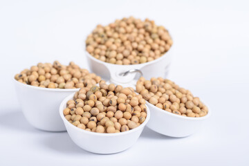 Soybean seeds in a bowl on white background