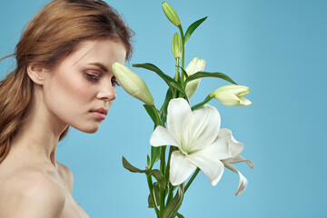 Attractive Lady white flowers blue background portrait cropped view