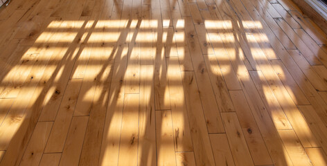 Vue d'un plancher de bois avec lumière du soleil créant un motif abstrait