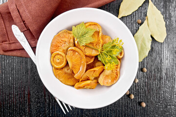 Mushrooms salted in plate on board top