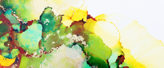 art photography of abstract fluid art painting with alcohol ink, green, yellow and gold colors