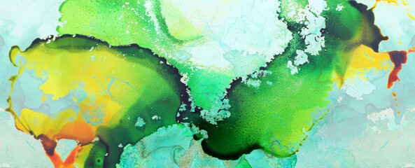 art photography of abstract fluid art painting with alcohol ink, green, yellow and gold colors