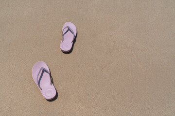 pink beach walk slippers or sandles of young woman placing on white beach and blue sea on summer vacation. travel concept
