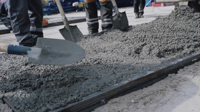 Pouring concrete mix from cement mixer on concreting at the factory