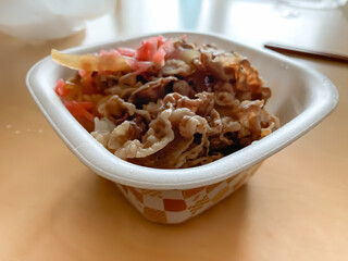 Close-up of beef bowl (Gyudon)  in plastic container for takeout