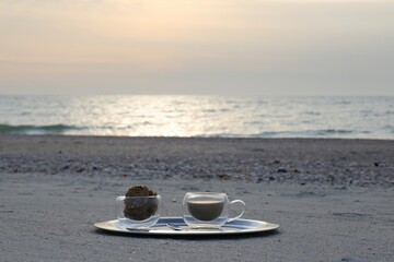 Fototapeta na wymiar cup of coffee on the beach