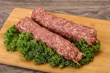 Raw minced beef kebab skewer