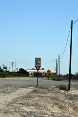 Truck route with a yield sign below