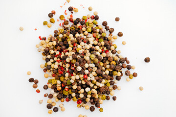 a mixture of peppers is scattered on a white background.