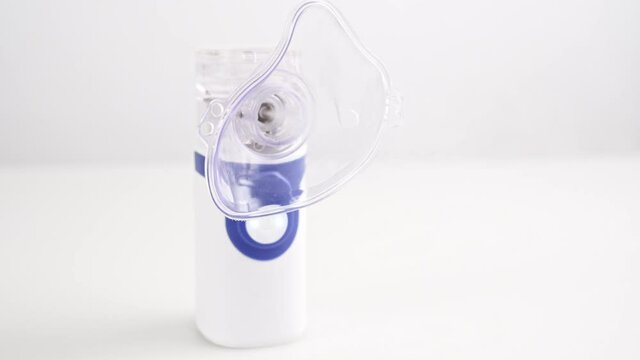 enabling the on button portable nebulizer. inhalation device.