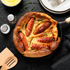 Toad in the hole, Sausage Toad, traditional English dish of sausages in Yorkshire pudding batter. top view