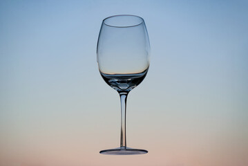 Floating empty wine glass with the sky behind