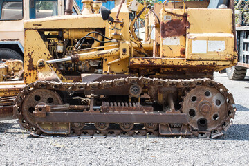 Fototapeta na wymiar steel tracks old weathered excavator in worksite.