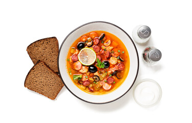 Traditional Russian meat soup Solyanka in bowl isolated on white background. top view	